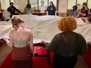 Students holding quilt