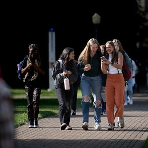 Students walking down sidewalk