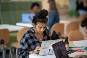 Student working on laptop in Knowlton Cafe