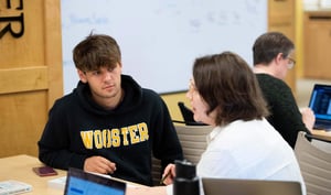 Student with staff member talking at a table