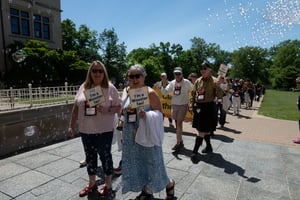 Alumni walking in parade during alumni weekend